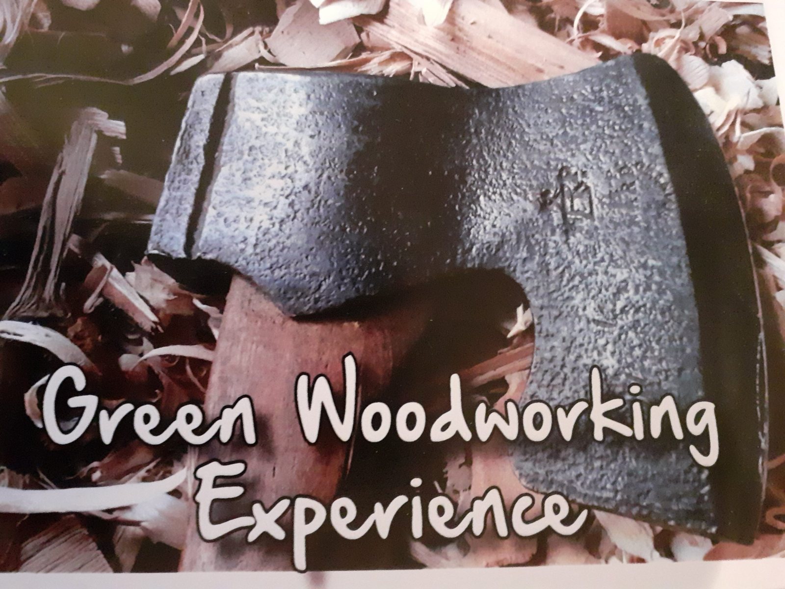 Green Woodworking Experience: an axe head resting on wood shavings